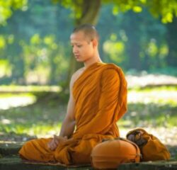 monge meditando num parque.